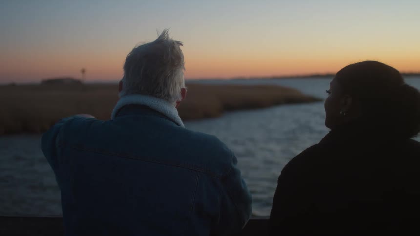 A man and woman watching the sunset together