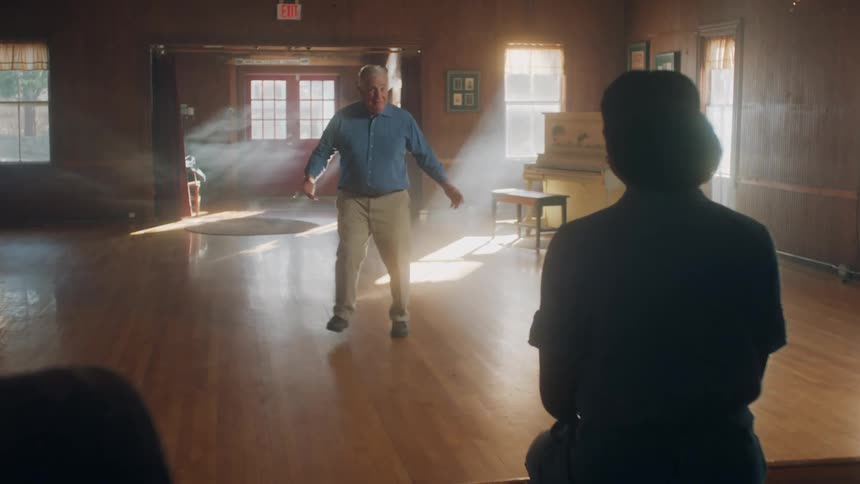 A man is dancing in the large room