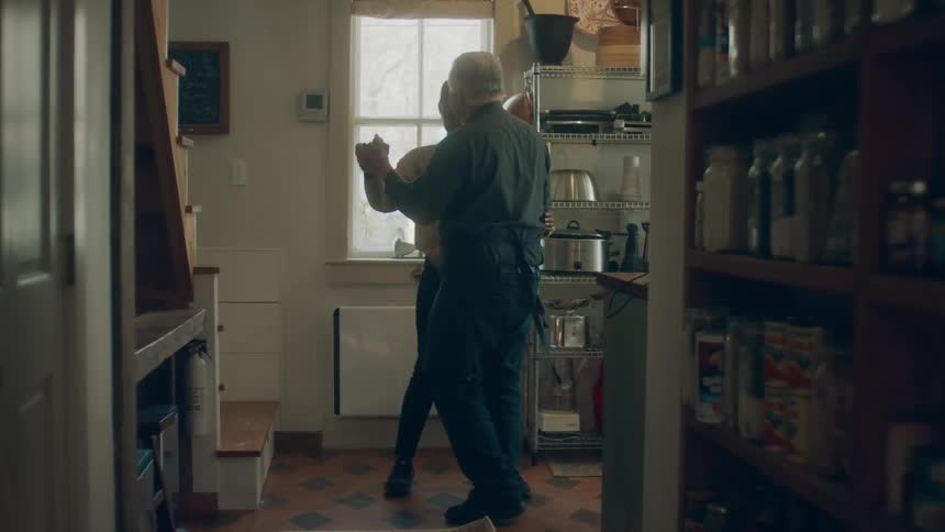 A man and woman dancing in a house