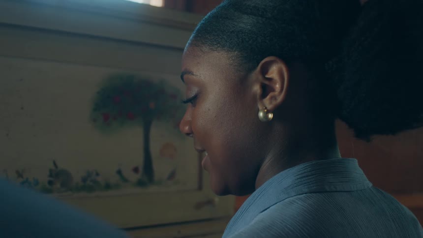 A woman is talking to someone indoors