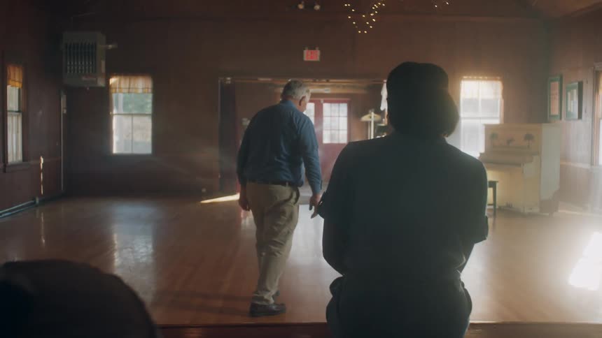 A man walks and dances in the hall