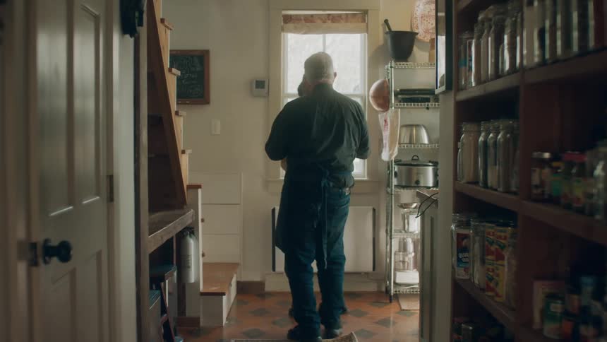 An elderly man helps a young woman down the stairs and they start dancing