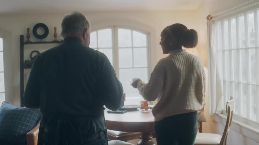 A woman walks down the hall with coffee