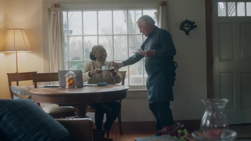 A man serves drinks to a woman