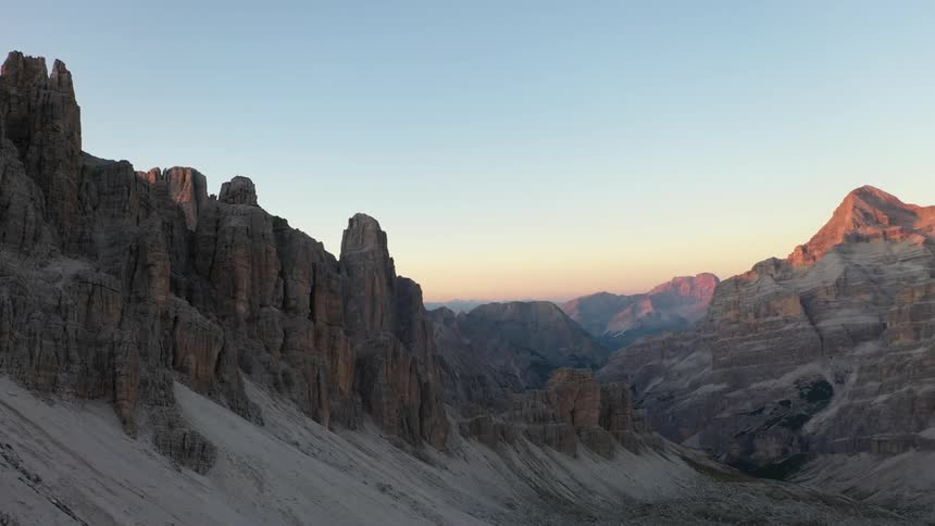 Rock formations peak high in a clear sky in the Italian Dolomites