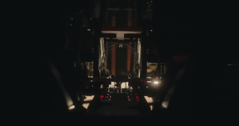 A bowling ball rolls through a bowling alley machine to be returned for use