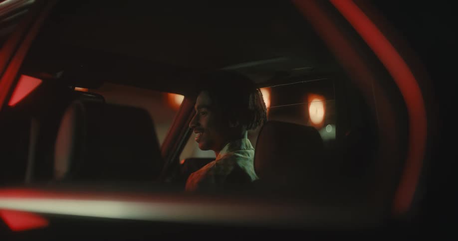A couple get into their vehicle and kiss