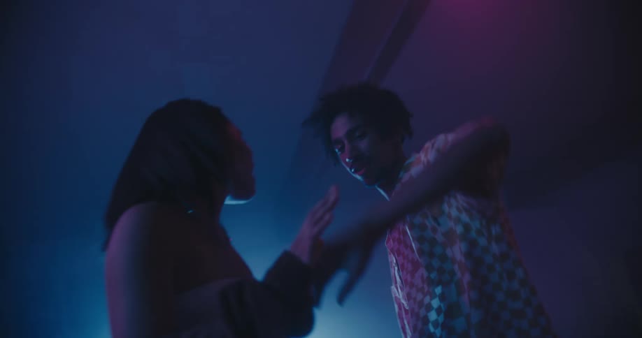 A man and woman dance together in a club