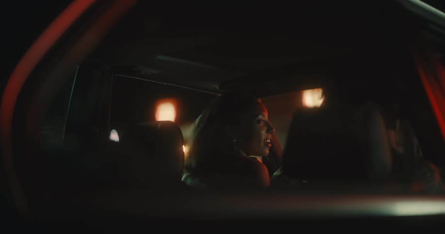 A woman and man talk while getting into their vehicle