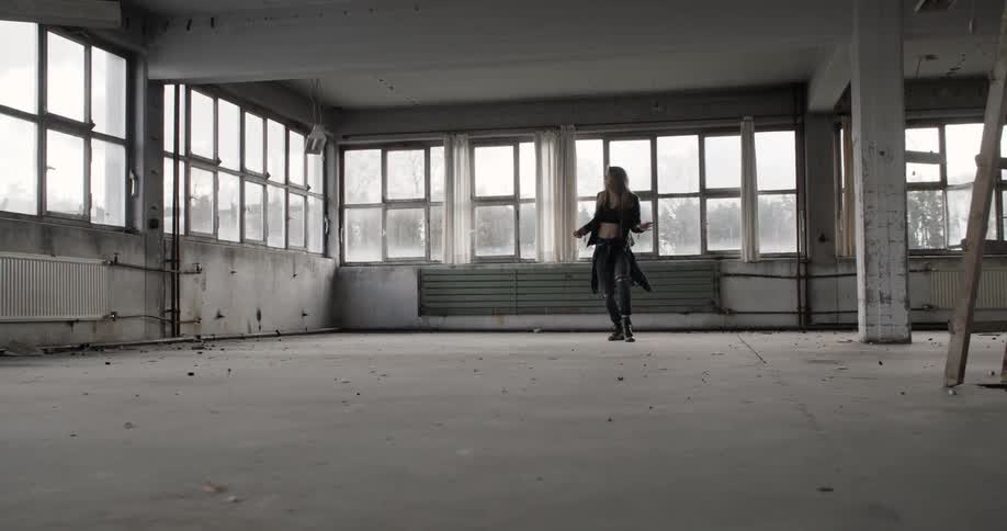 Woman dancing in an abandoned building
