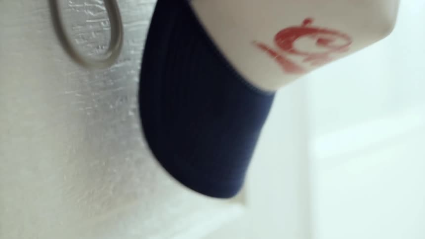 Baseball cap being removed from a hook