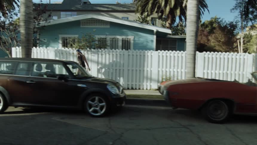 Woman skateboarding on a neighborhood sidewalk