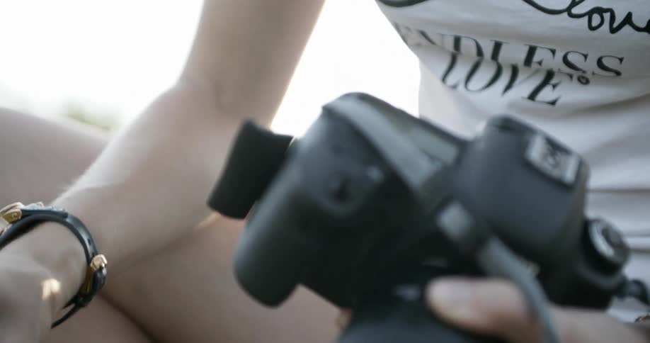 Woman takes battery out of camera