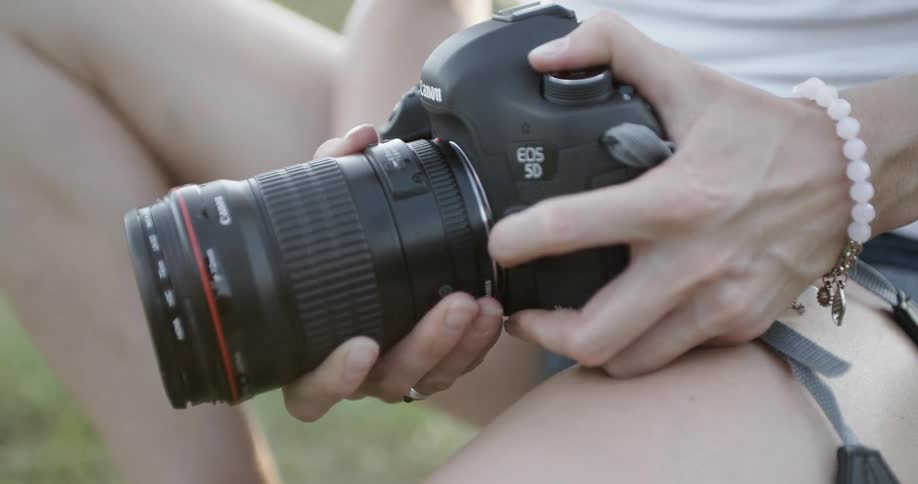 A woman takes apart her camera