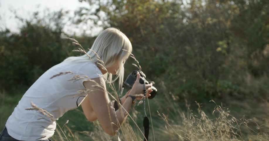 Woman outdoors taking photographs