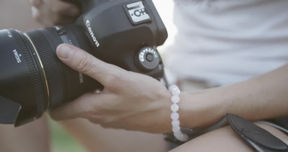 A person is examining a camera in their hands