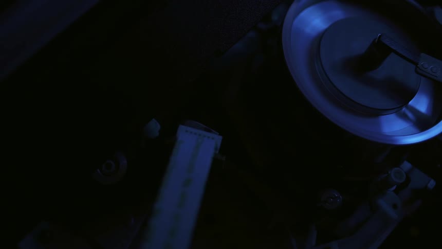A machine turns on in a dark area