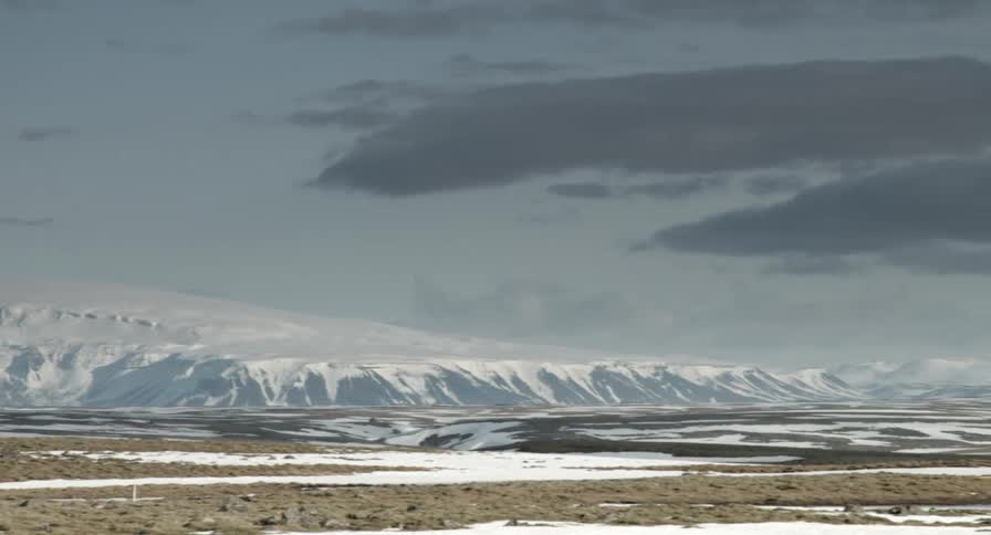 Snowy mountains on a partly cloudy day