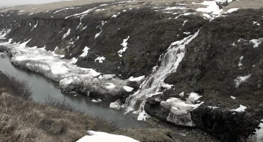 Water flowing down a hillside into a river