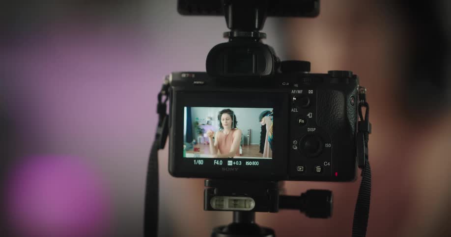 A woman puts on makeup as she films herself