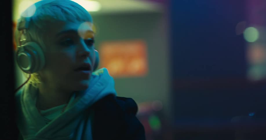 A woman is dancing and listening to music
