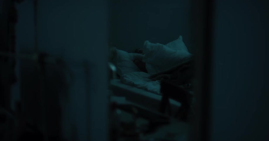 Young white woman lying in her bed leafing through a magazine and then turning off the light and going to sleep