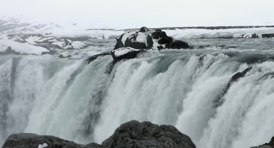 View of the top of a waterfall on a cloudy day