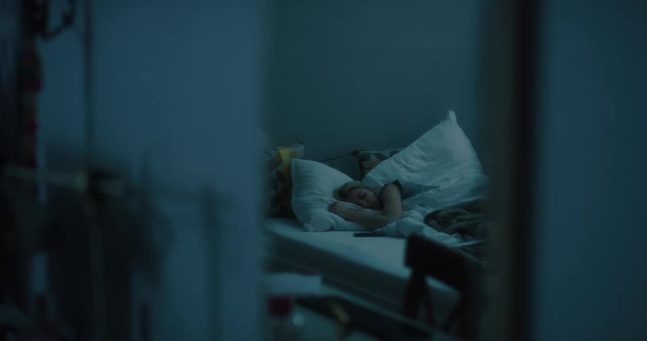 Mirror reflection of a woman sleeping in the bed at her bedroom