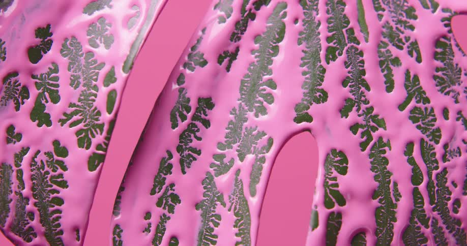 Pink paint partially covering a green plant leaf in front of a pink background
