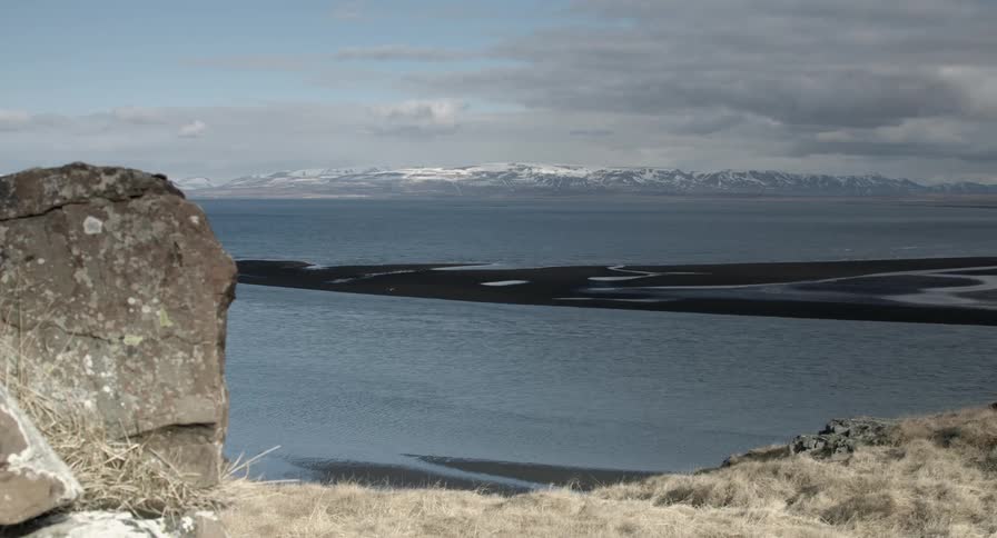 View of a large body of water as seen from a cliff edge