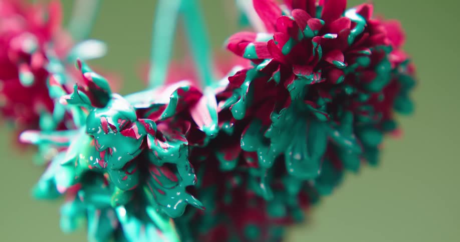 Closeup of pink carnations covered in turquoise paint