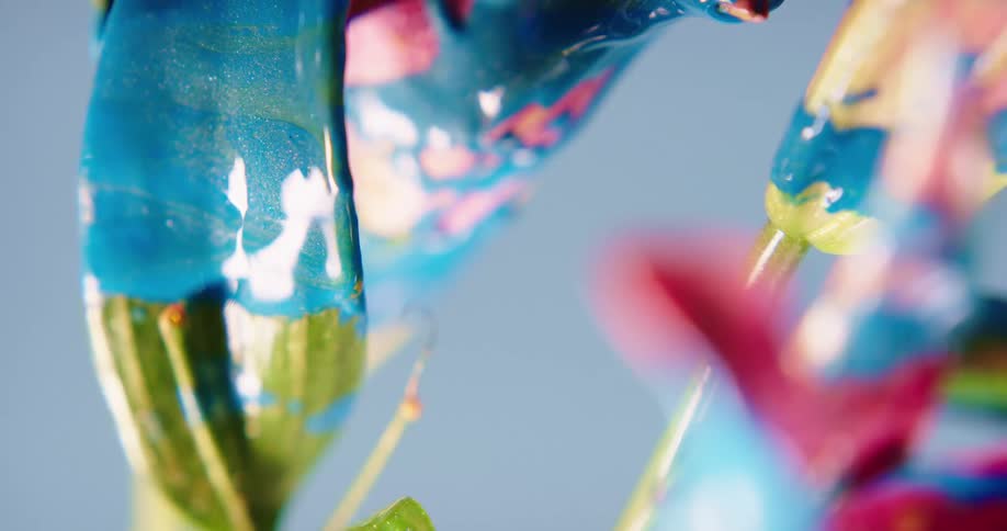 The neon paint drips from the plant
