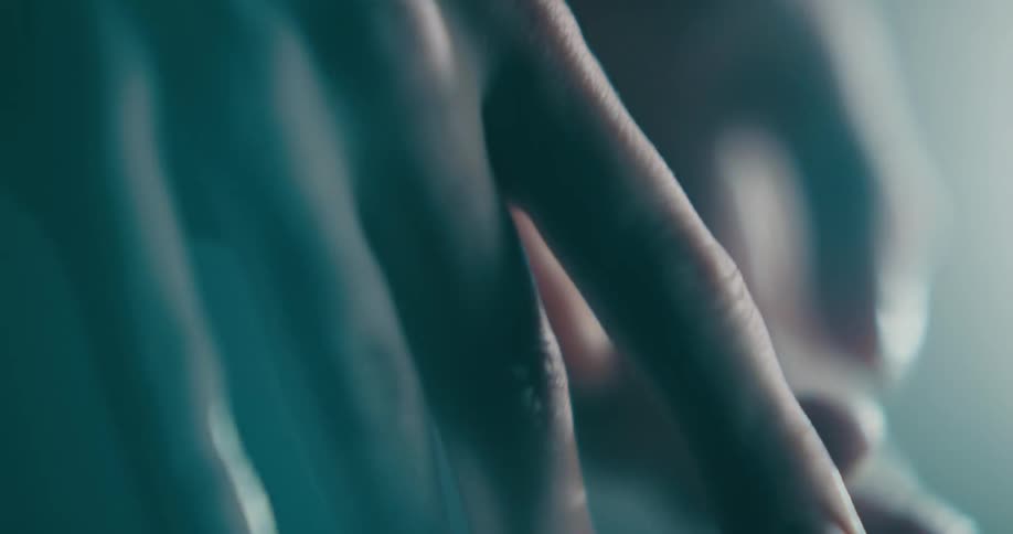 A woman rubs and intertwines her fingers together