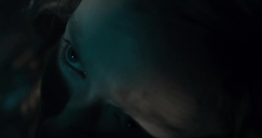 A woman wakes up after a dark shadow washes over her face and lights come on