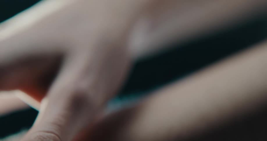 A woman runs her fingers along her forearm