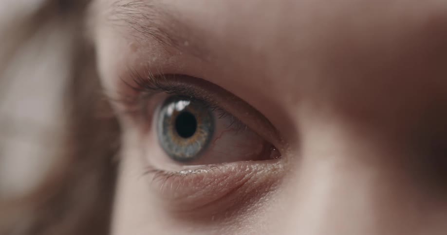 White person blue eye squinting and blinking