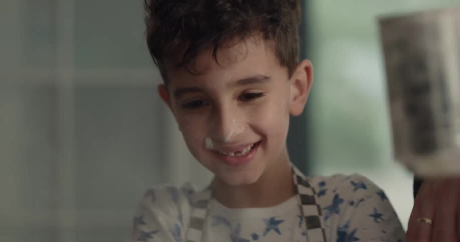 Father and son playing with flour while cooking in the kitchen at home