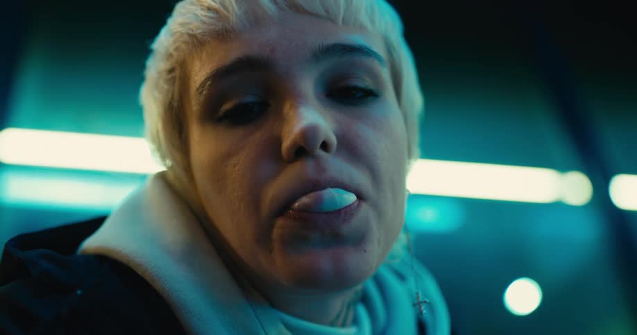 A woman rolls her eyes after trying to a bubble with her chewing gum