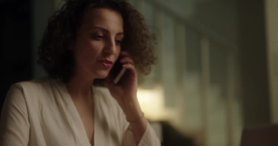 A woman picks up her phone and talks