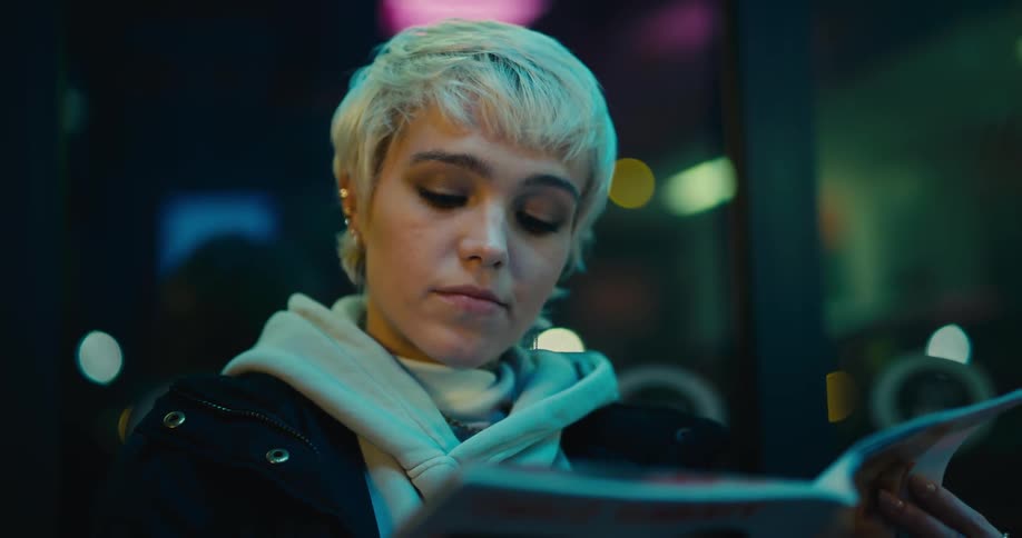 A teenage girl flips through a magazine