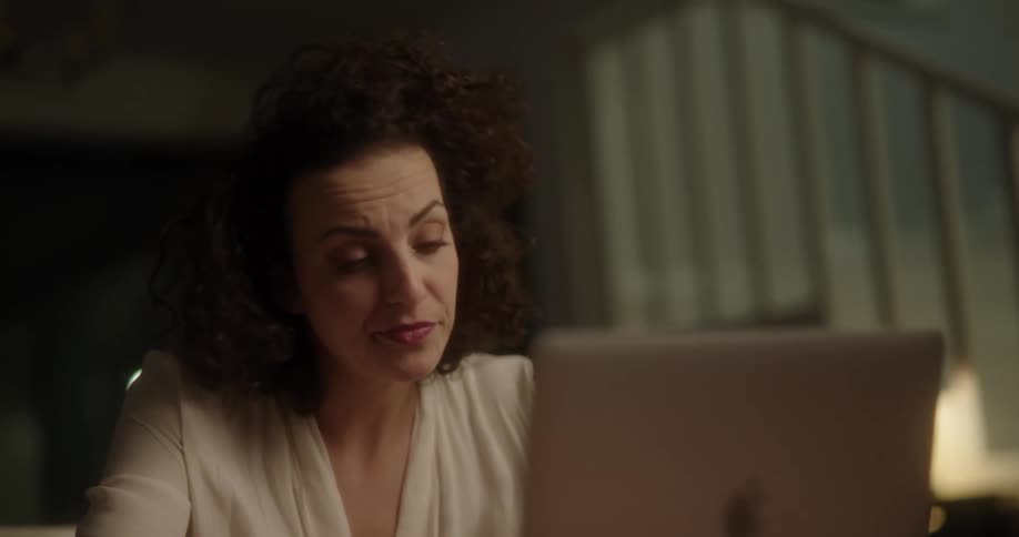 A woman is upset while using her laptop