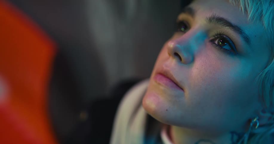 A woman looks up at the ceiling while sitting in a chair