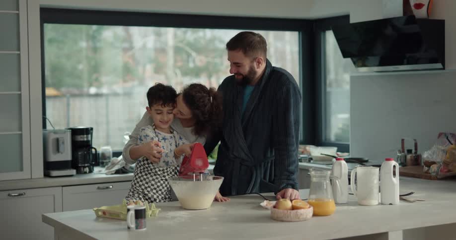 A family is cooking breakfast together in the daytime