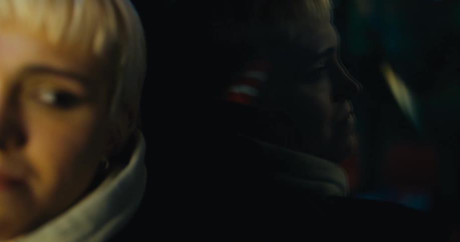 A girls face and her reflection in a bus window
