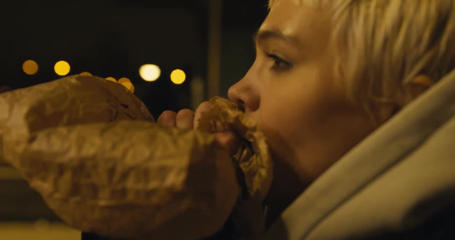 A woman is breathing into a paper bag