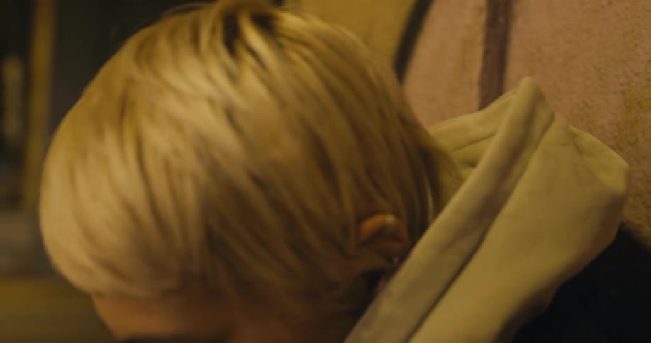 Blonde woman hyperventilating near street uses paper bag