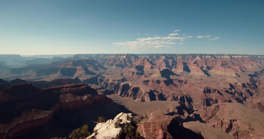 A vast canyon in the badlands under a clear blue daytime sky