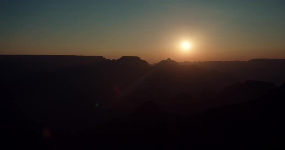 Aerial view of the sun setting in the horizon is displayed