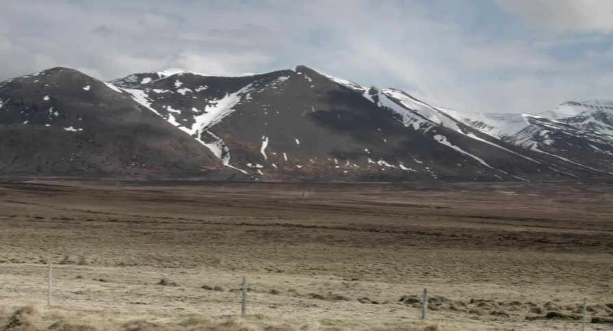 Mountains near a field on a cloudy day