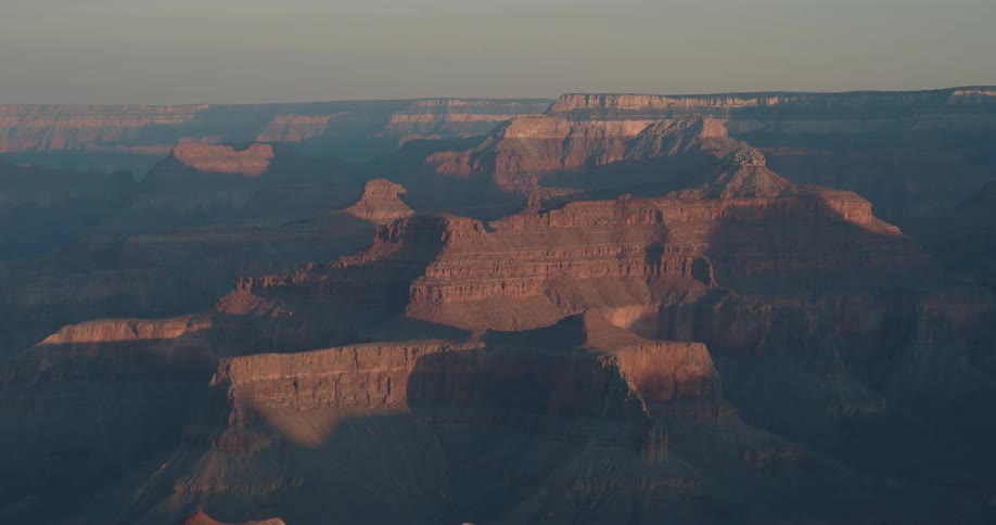 Sunlight hits the top of the canyon rock formations